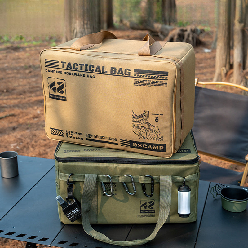Two tactical camping cookware bags stacked on an outdoor table in a forest setting.