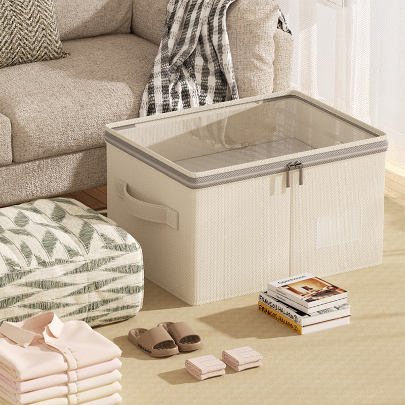 Cream linen-cotton storage box with clear zip lid, styled in a cozy living room.